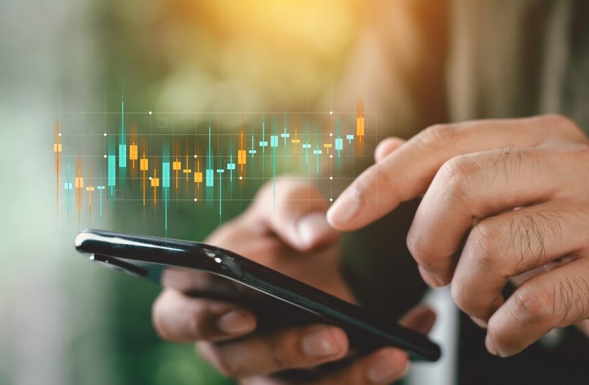 Businessmen,Investor,Think,Before,Buying,Stock,Market,Investment,Using,Smartphone Piețele financiare reacționează prudent la tensiunile din Orientul Mijlociu; analiștii anticipează volatilitate moderată, dar persistentă